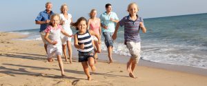 Family running on the beach