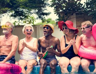 Group of seniors sitting by pool
