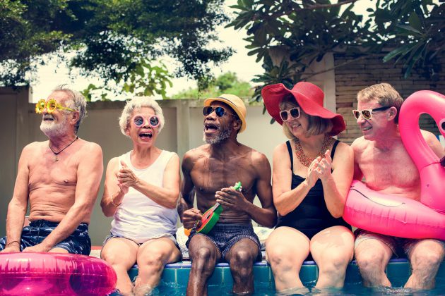 Group of seniors sitting by pool